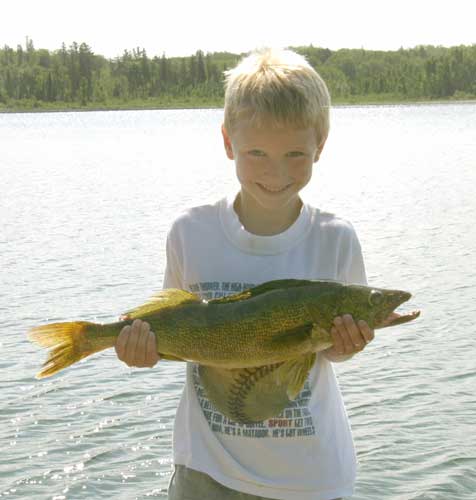 smiling boy holding fish